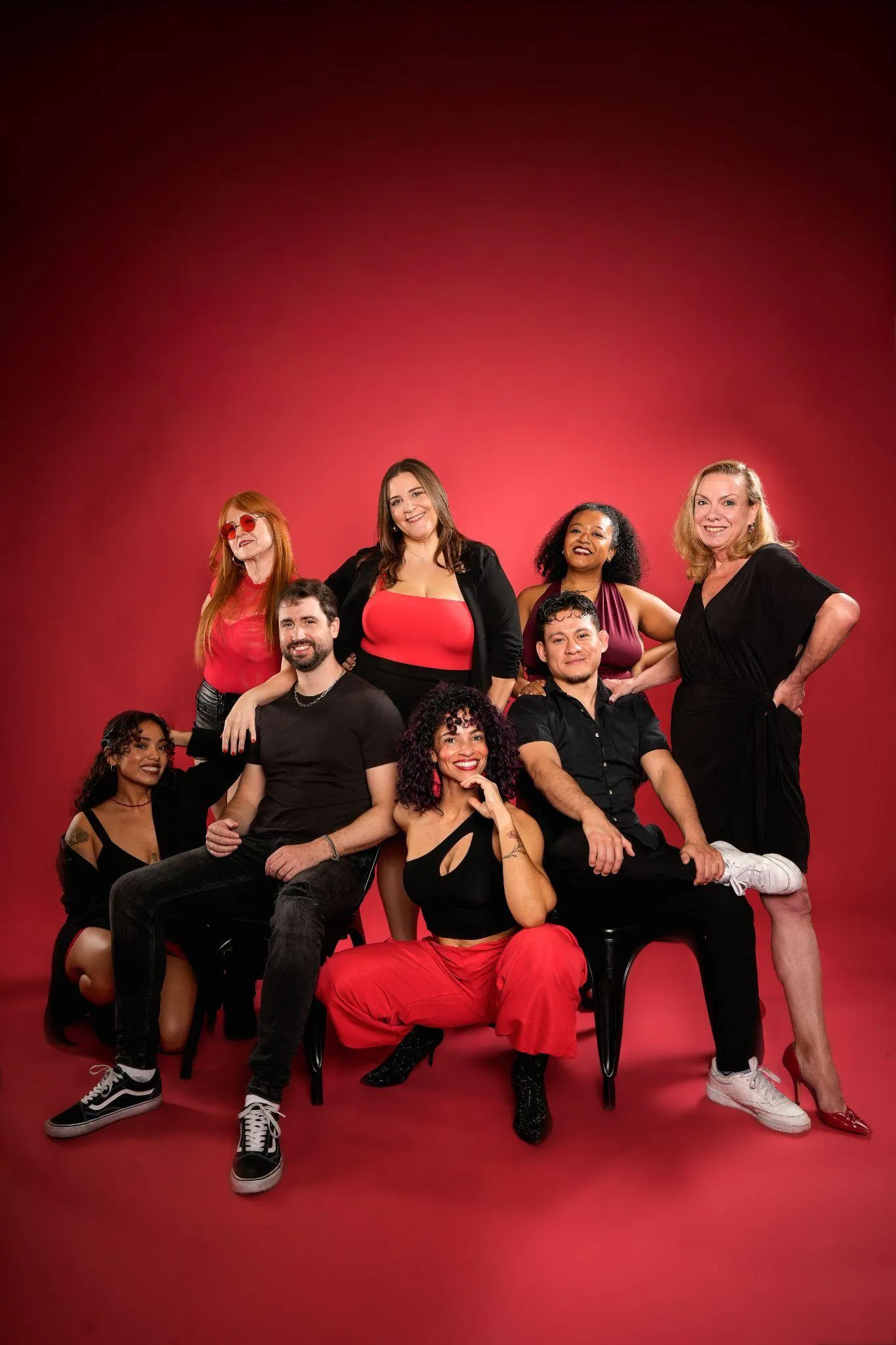group-posing-red-backdrop