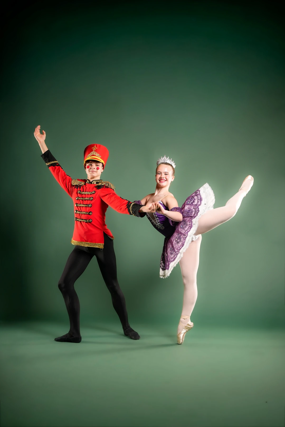 Two Jordance Studios dancers in Nutcracker costumes, a toy soldier and the Sugar Plum Fairy balanced on pointe